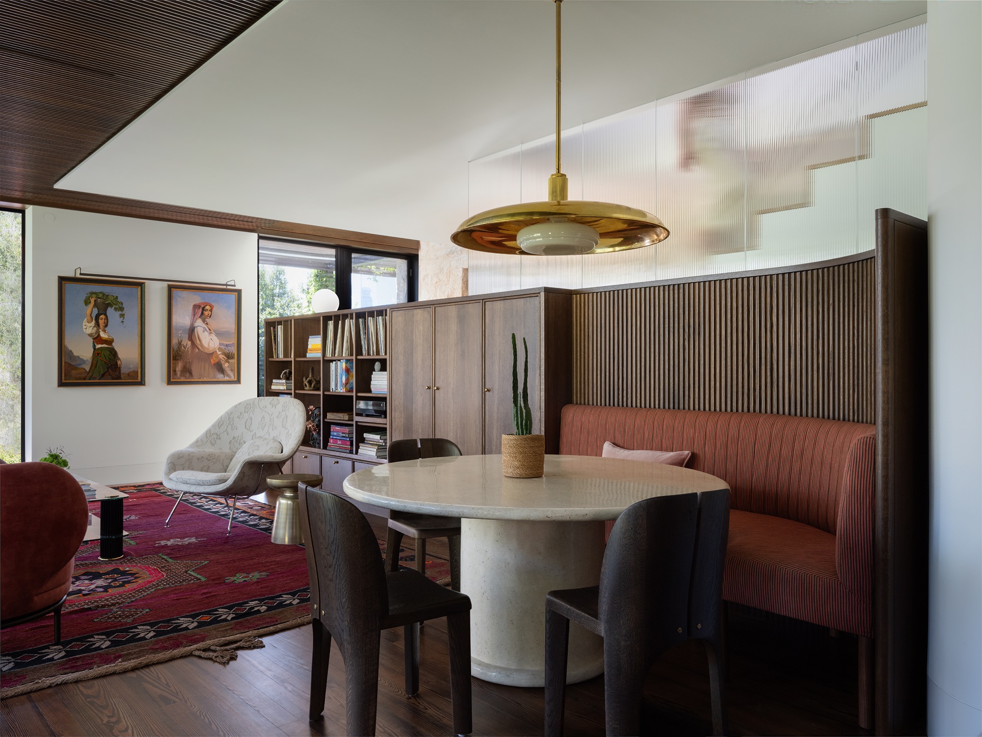 Victorian House built-in banquette beside ribbed glass stair in Austin, Texas