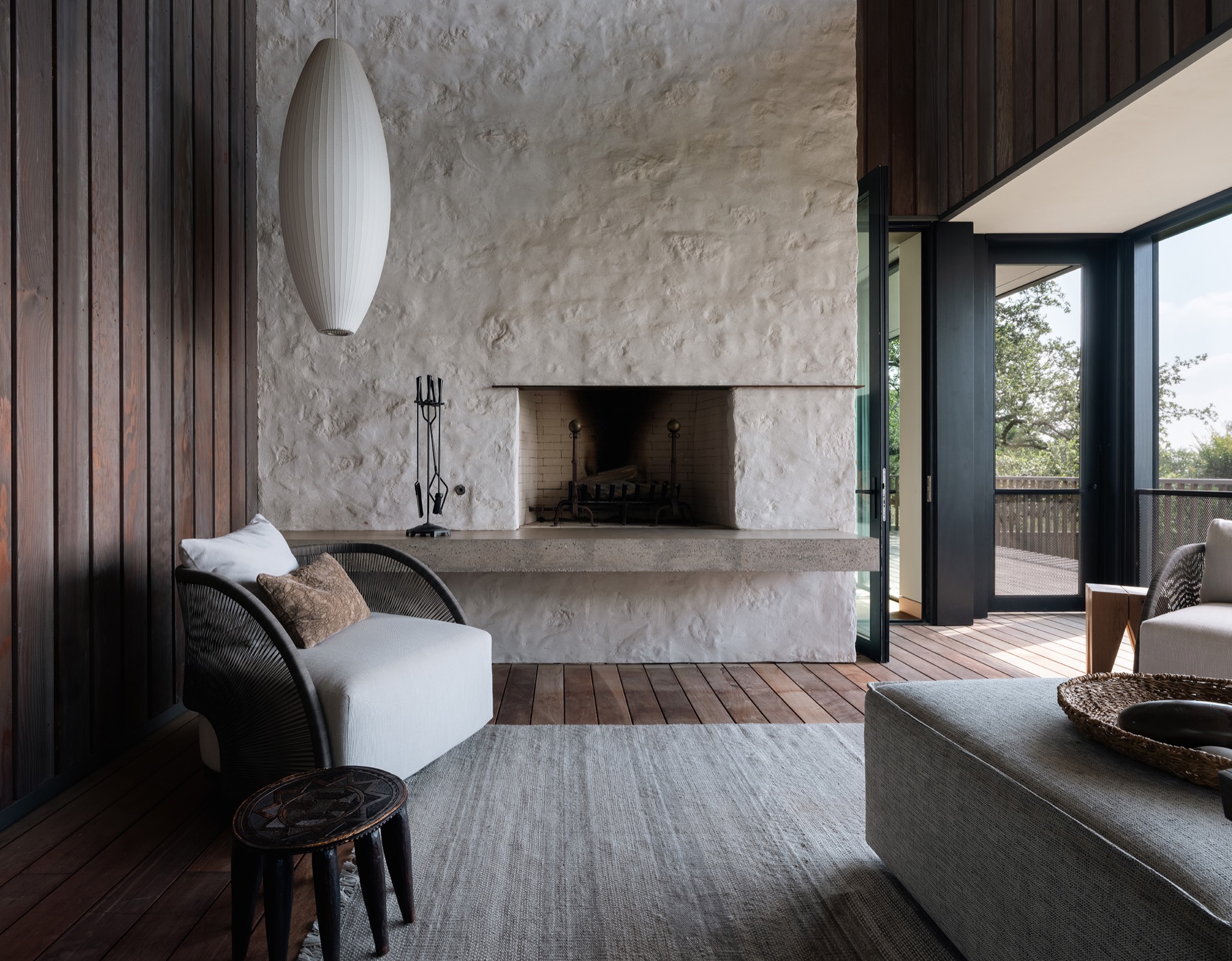 Hillside House screened porch with fireplace in West Lake Hills, Texas