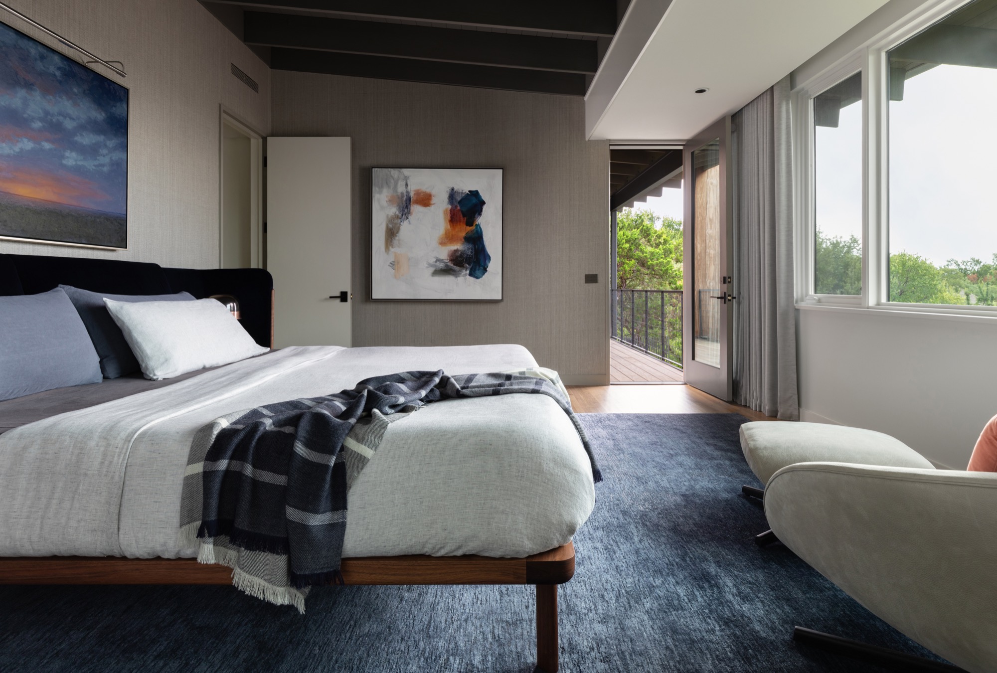 Bedroom of a modern Austin house opening to a terrace